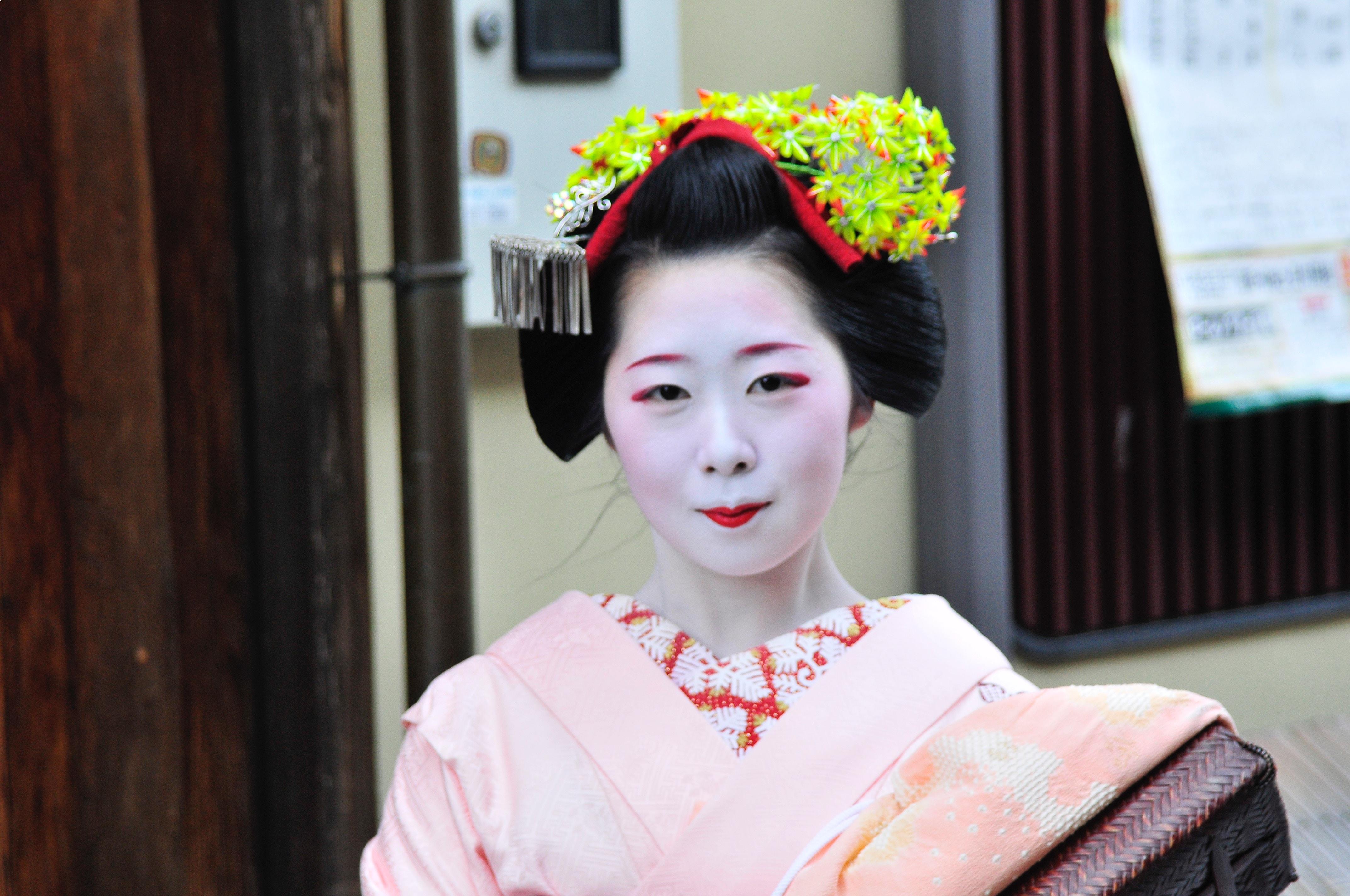 Maikos are Geishas in training. Captured in this image is a young Maiko. Fully devoted to the art of Geishas. These individuals are representative of Kodawari.